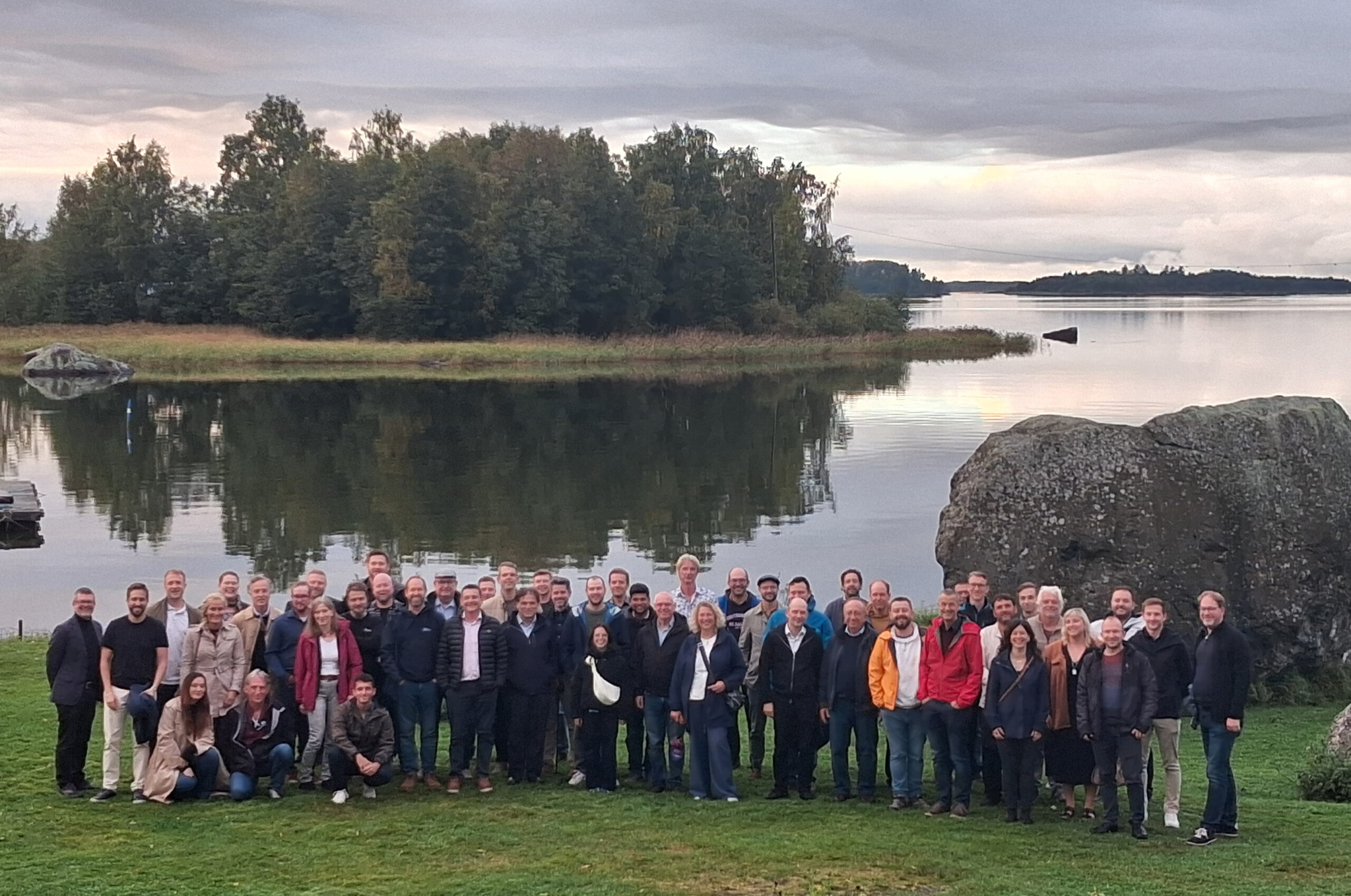 A group of people on a Finnish lakeside.